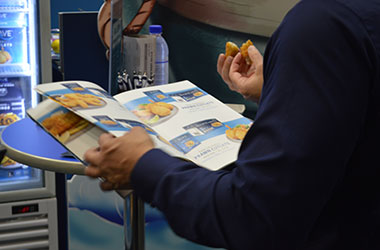 Chefs tasting freshly cooked Blue Wave seafood at Fine Food Sydney