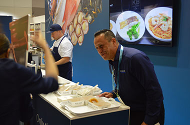 Chefs tasting freshly cooked Blue Wave seafood at Fine Food Sydney
